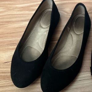 Well worn black ballet flats